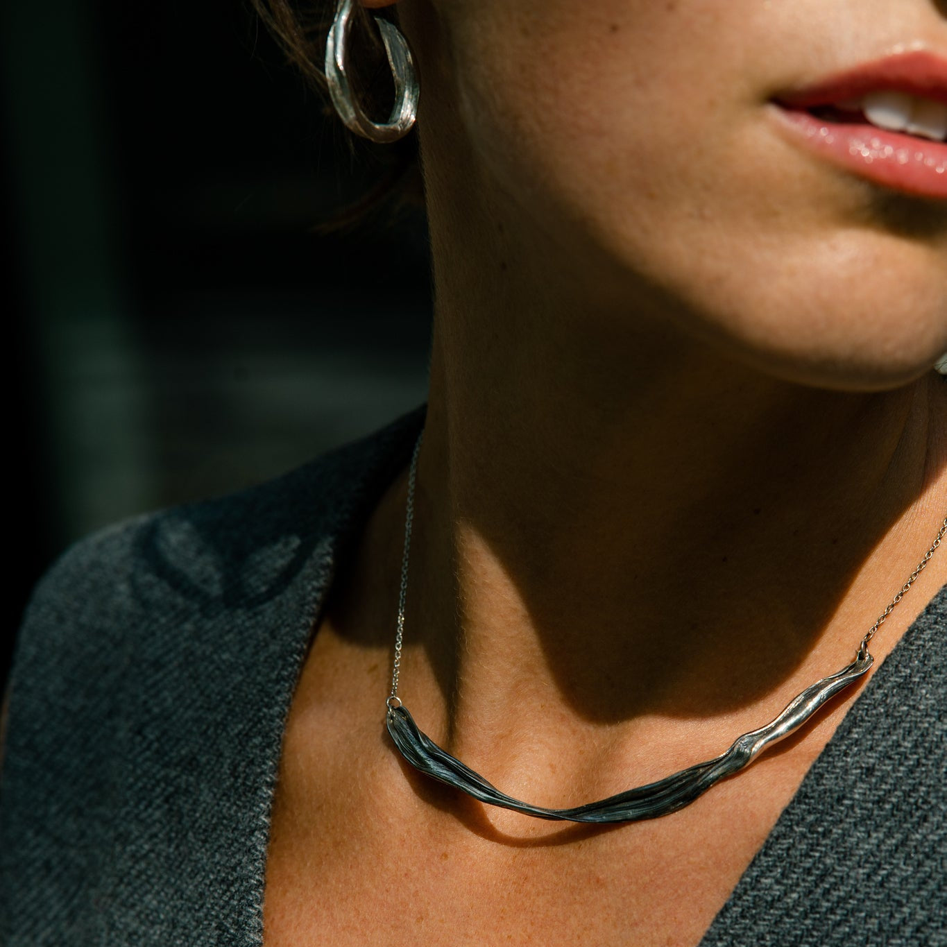 Young woman with pink lips wearing silver jewelry made by what if you stayed 