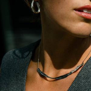 Young woman with pink lips wearing silver jewelry made by what if you stayed 